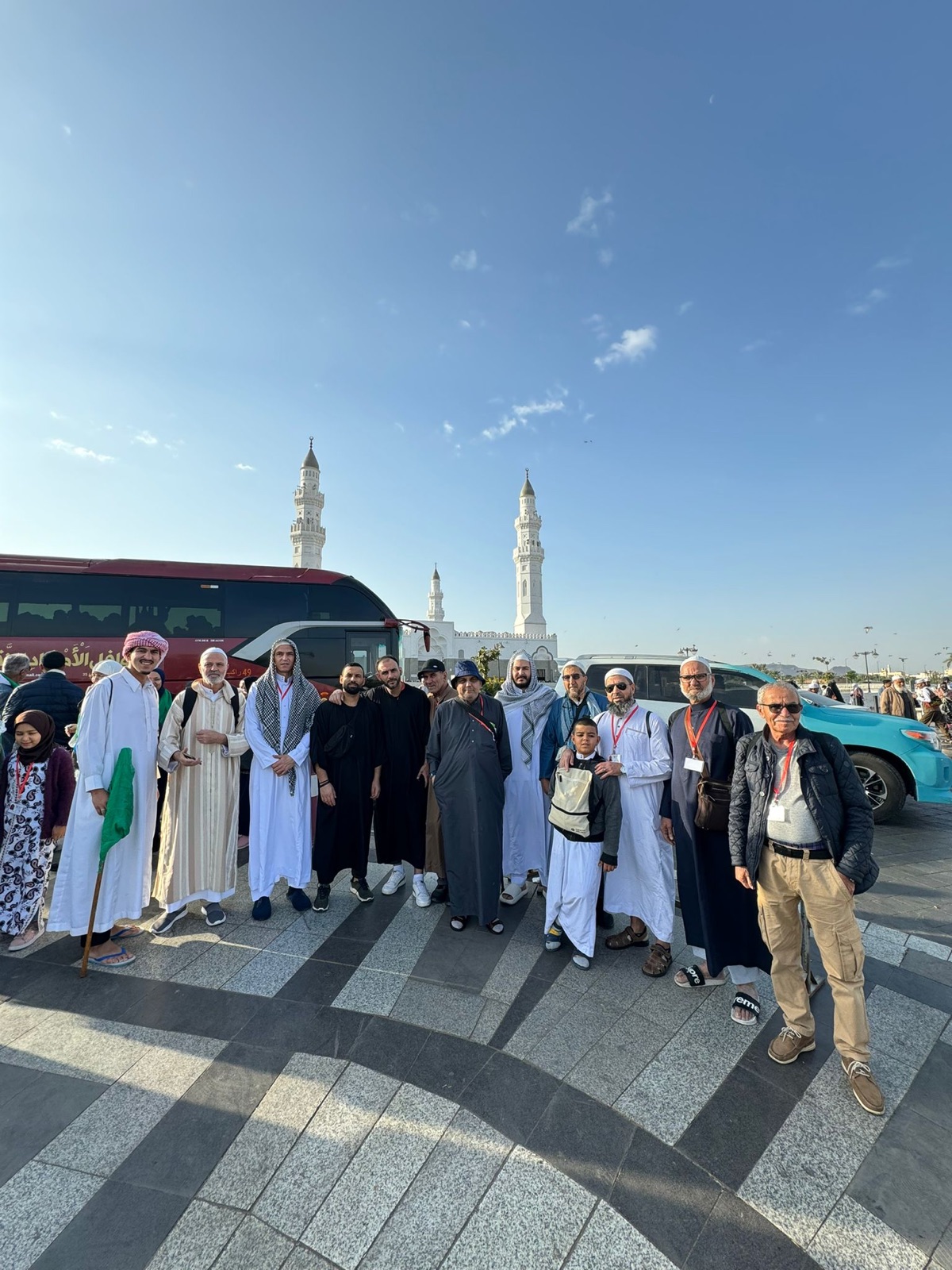 Group at Masjid al-Quba with bus
